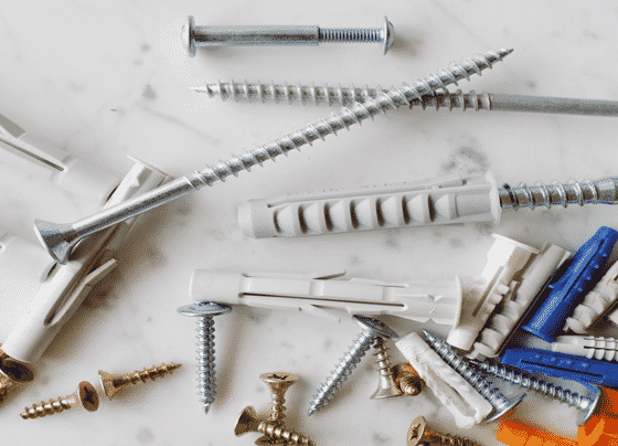 Bunch Of Plastic Dowels With Metal Screws — H&D Building Supplies in Heatherbrae, NSW Bunch Of Plastic Dowels With Metal Screws — H&D Building Supplies in Heatherbrae, NSW