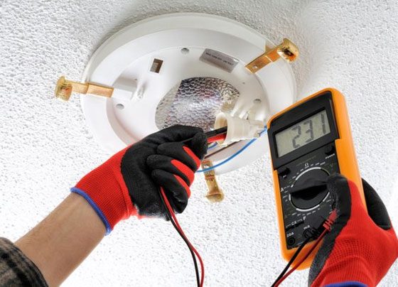 Electrician Measures The Voltage In Light— H&D Building Supplies in Heatherbrae, NSW