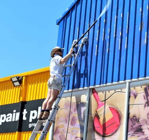 Man Painting Roof — H&D Building Supplies in Heatherbrae, NSW