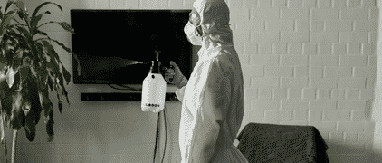 Person Holding Spray Bottle Wearing PPE — H&D Building Supplies in Heatherbrae, NSW