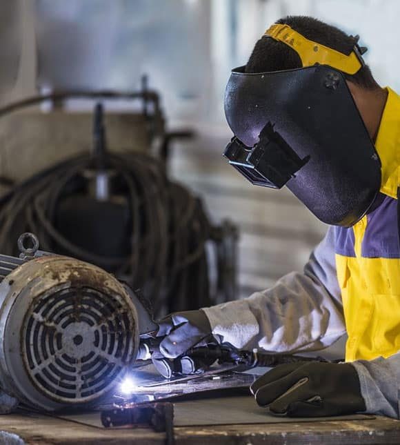 Worker Welding Steel — H&D Building Supplies in Heatherbrae, NSW