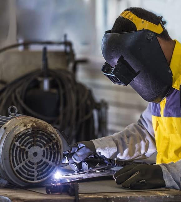 Worker Welding Steel — H&D Building Supplies in Heatherbrae, NSW Worker Welding Steel — H&D Building Supplies in Heatherbrae, NSW
