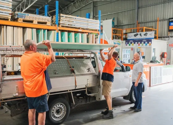 H&D staff loading sheet materials onto a customer ute