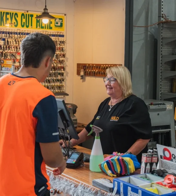 H&D staff serving a customer at the hardware counter
