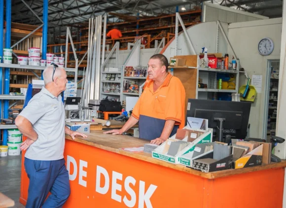 H&D staff member serving a customer at the trade desk